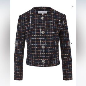 Collarless cropped silhouette, signature crest buttons.